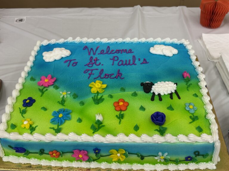 Celebration Cake that reads "Welcome to St Paul's Flock"
