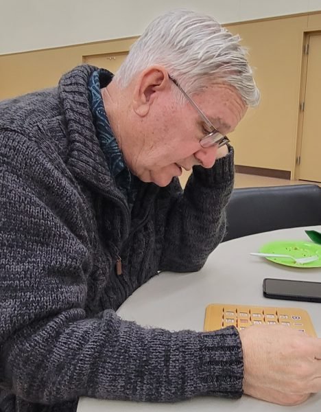 A man looking at a bingo card