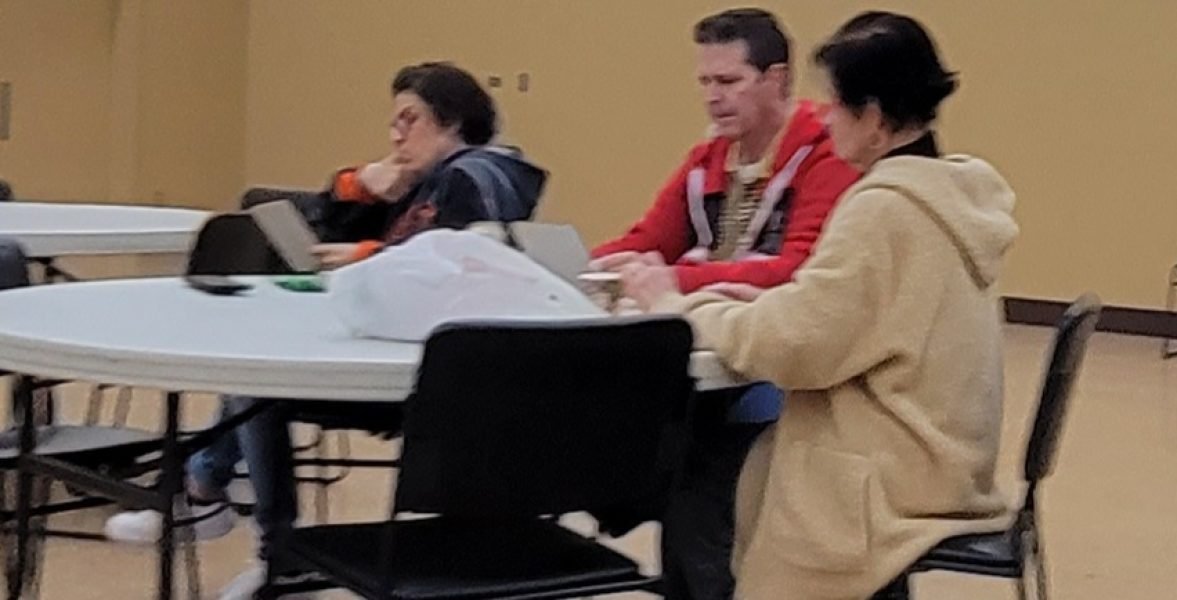 A group of people sitting around a table playing bingo