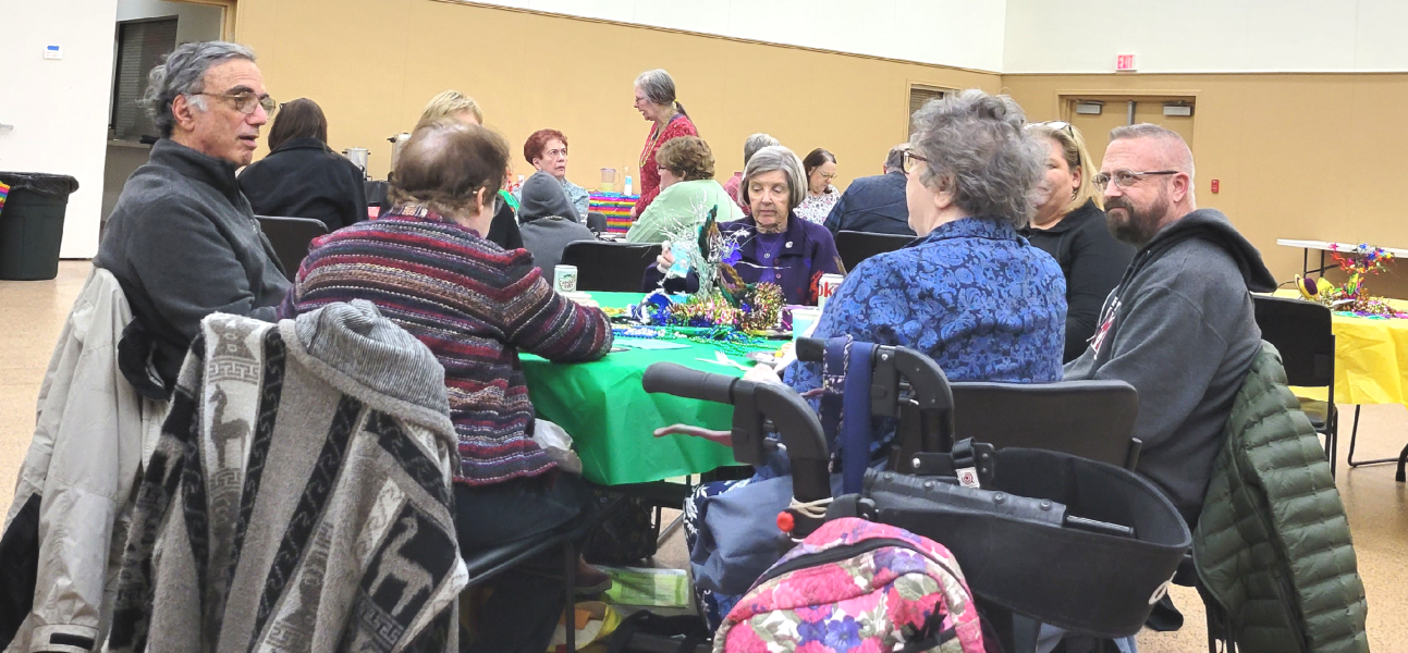 A group of people sitting around a round table