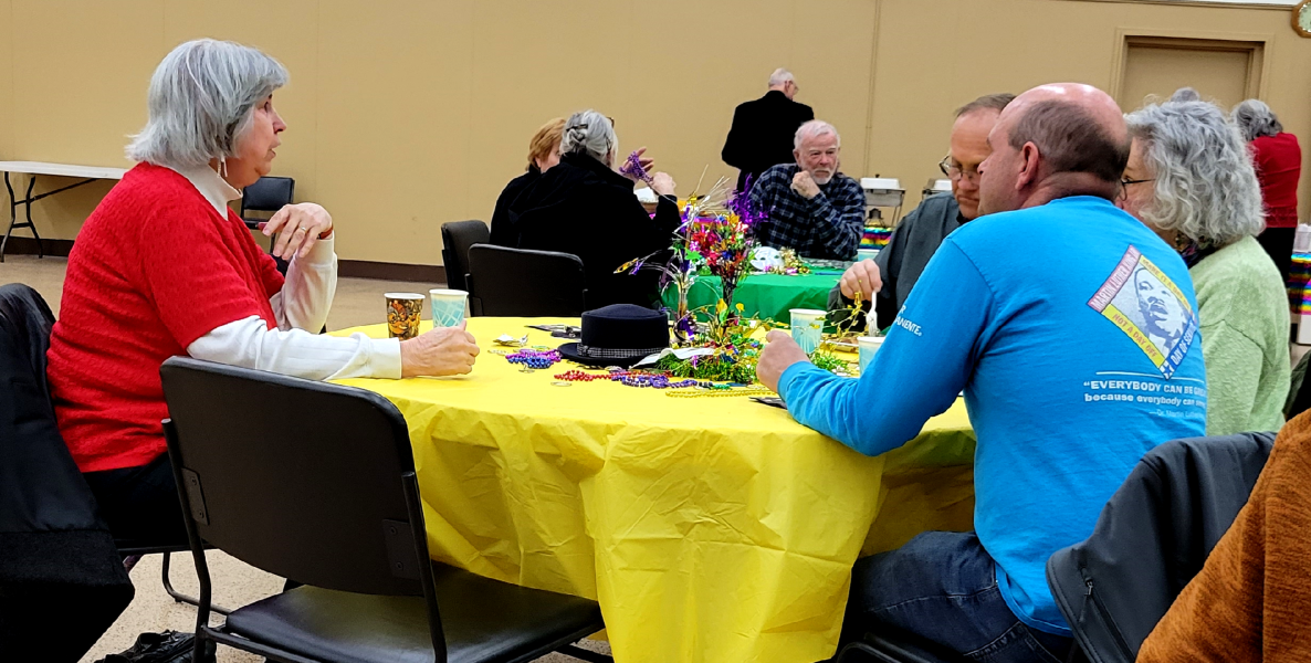 A group of people sitting around a round table