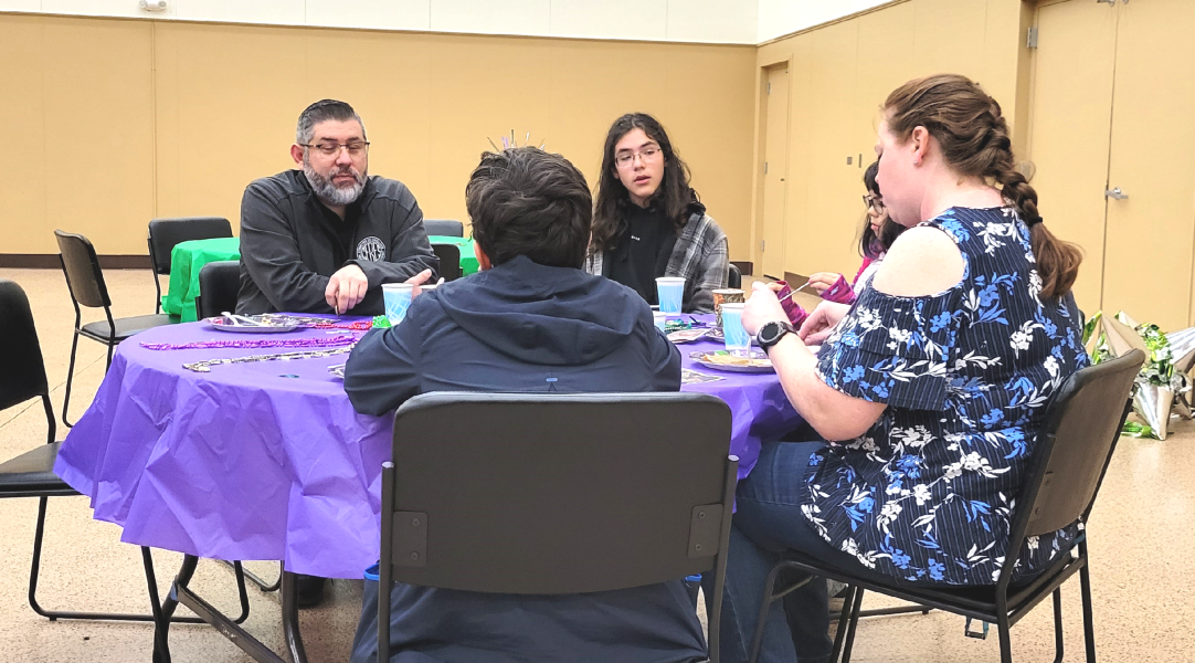 A group of people sitting around a round table