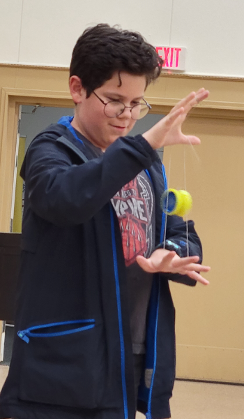 A kid doing a yo-yo trick