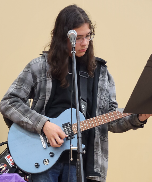 A kid playing the guitar