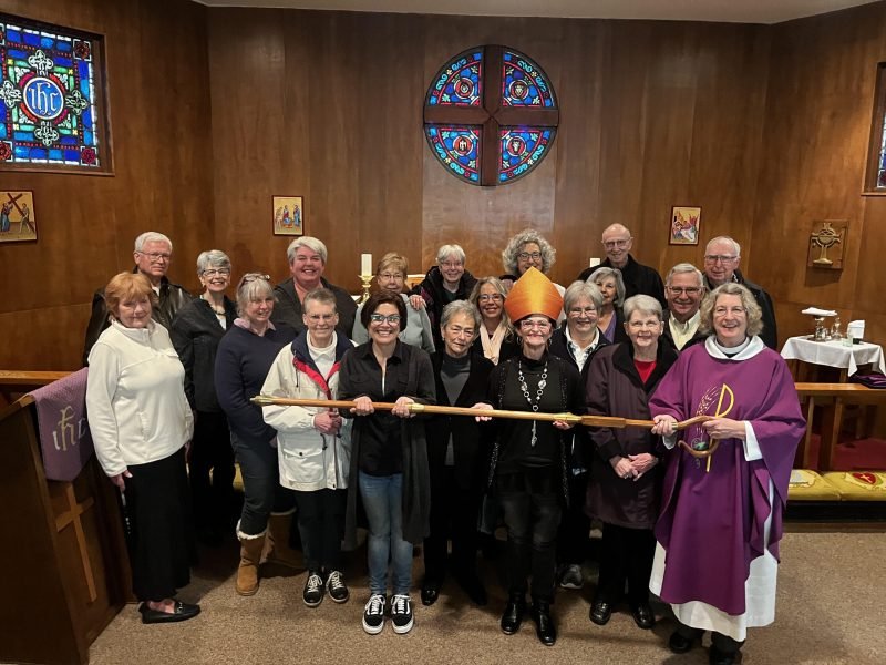 A large group of people lined up taking a photo at church